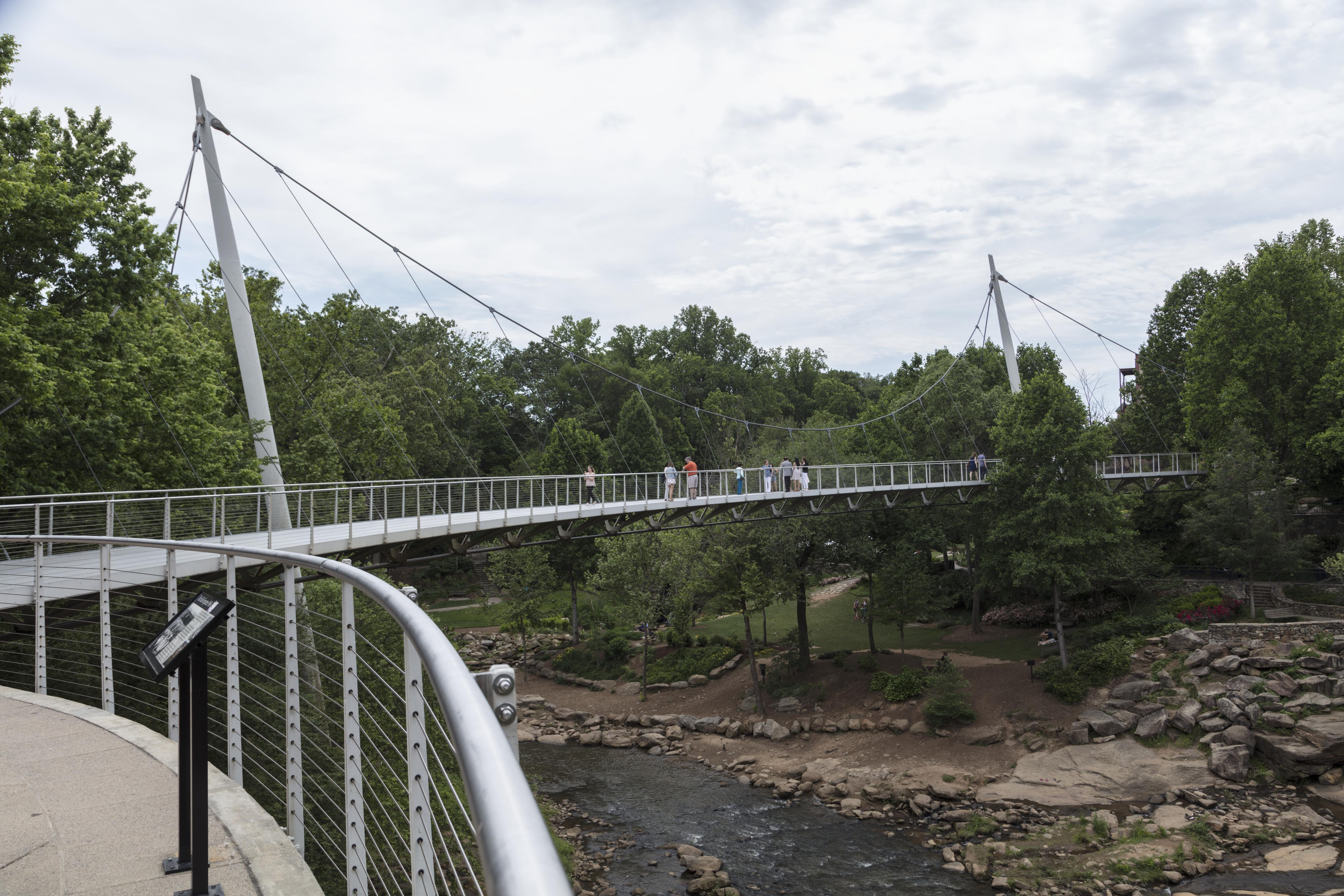 The Liberty Bridge suspended above a river gorge, held by its cables