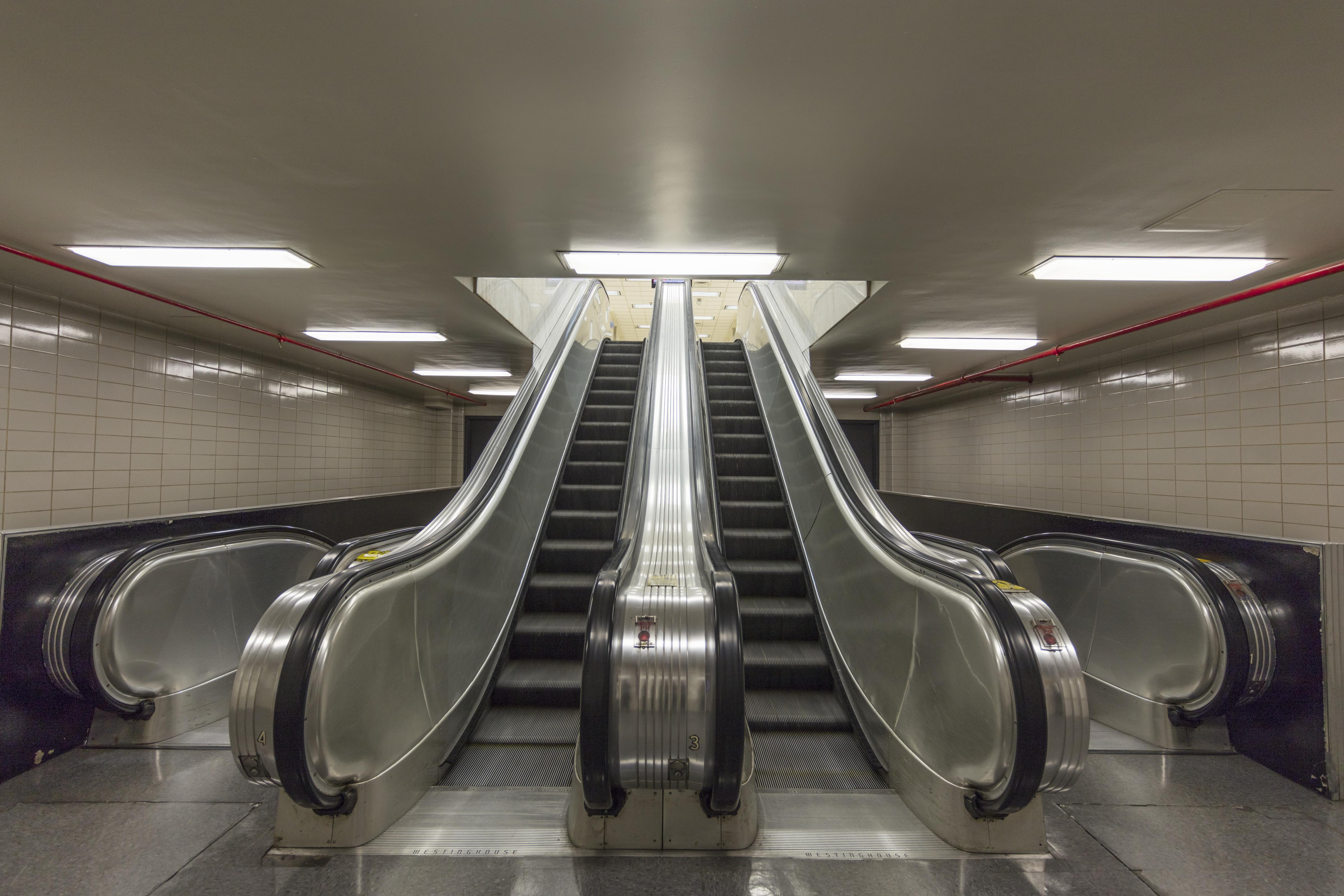 Paired escalators in precise parallel motion