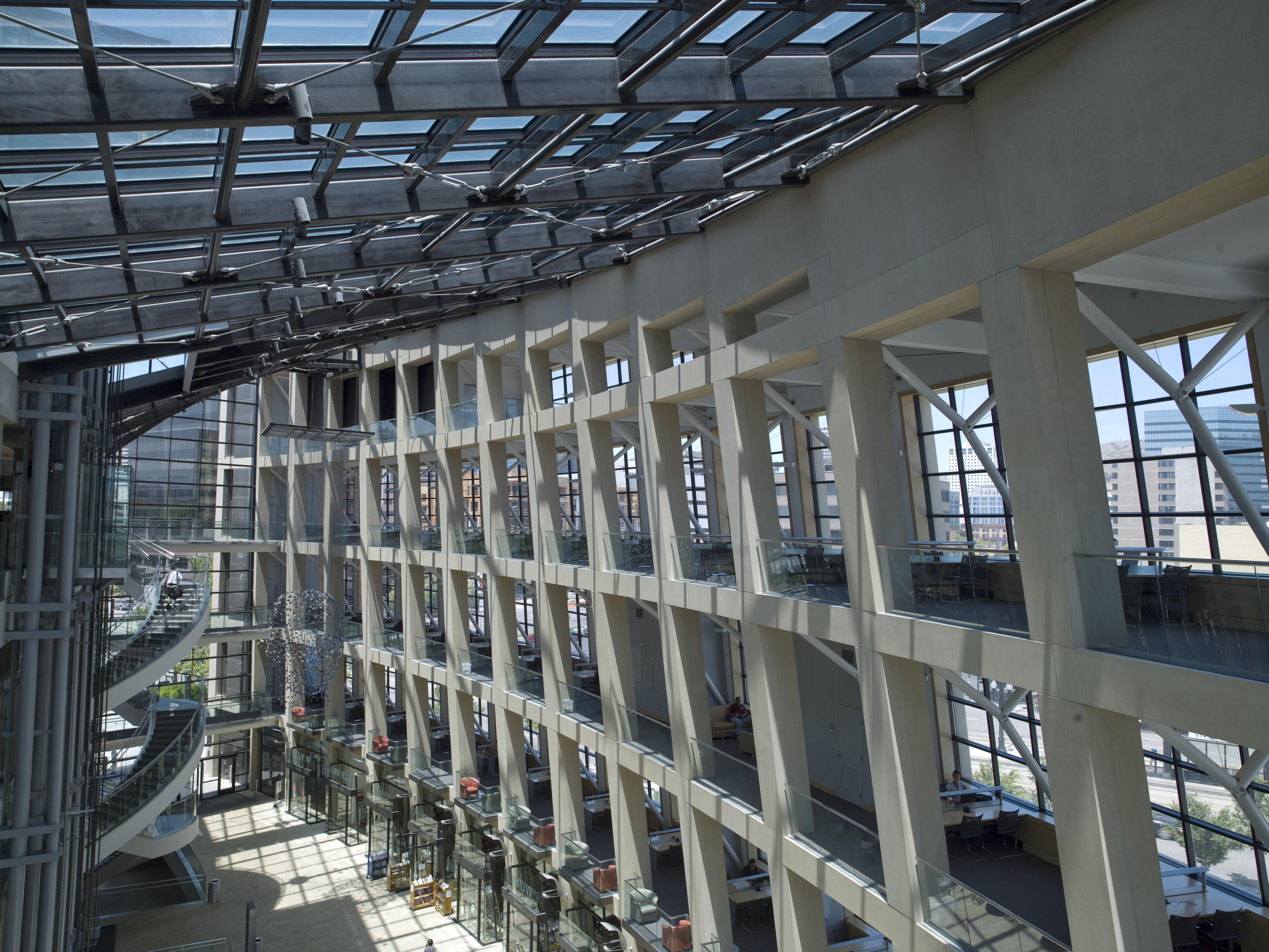 Sunlit curved atrium of the Salt Lake City Public Library, walkways in motion