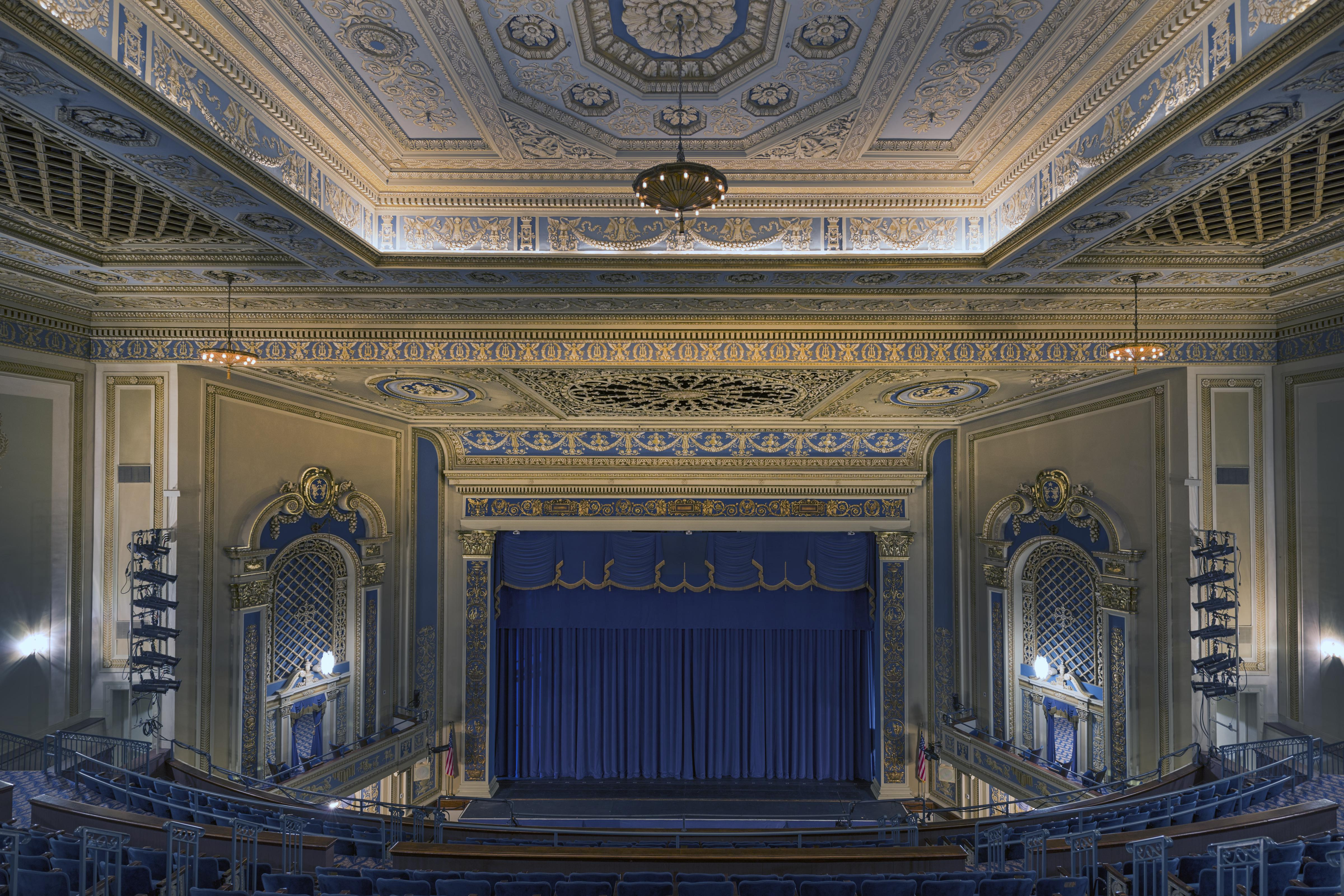 The gilded auditorium of the Perot Theatre, its stage lit and waiting