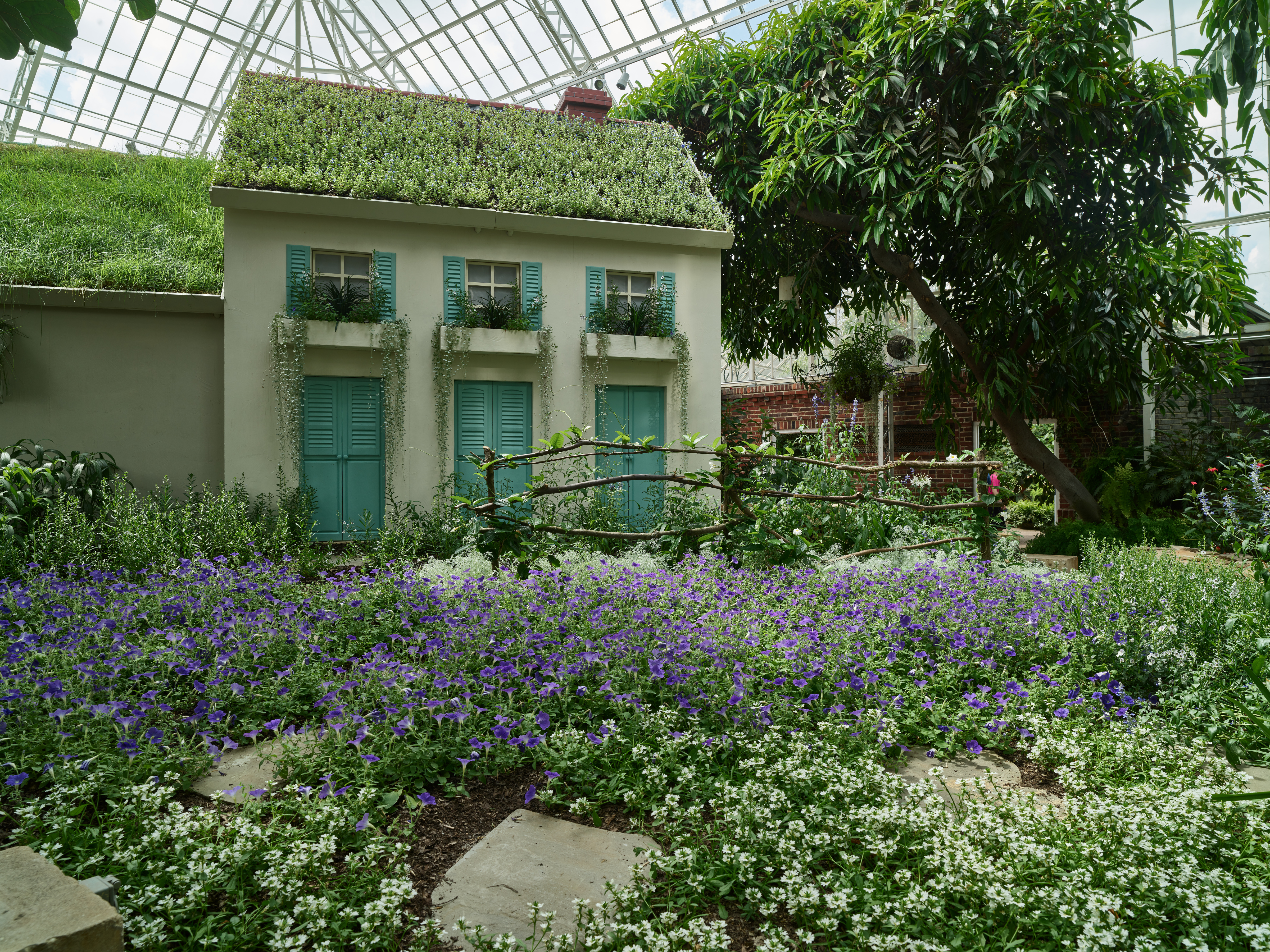 The planted entrance of Phipps Conservatory drawing visitors in