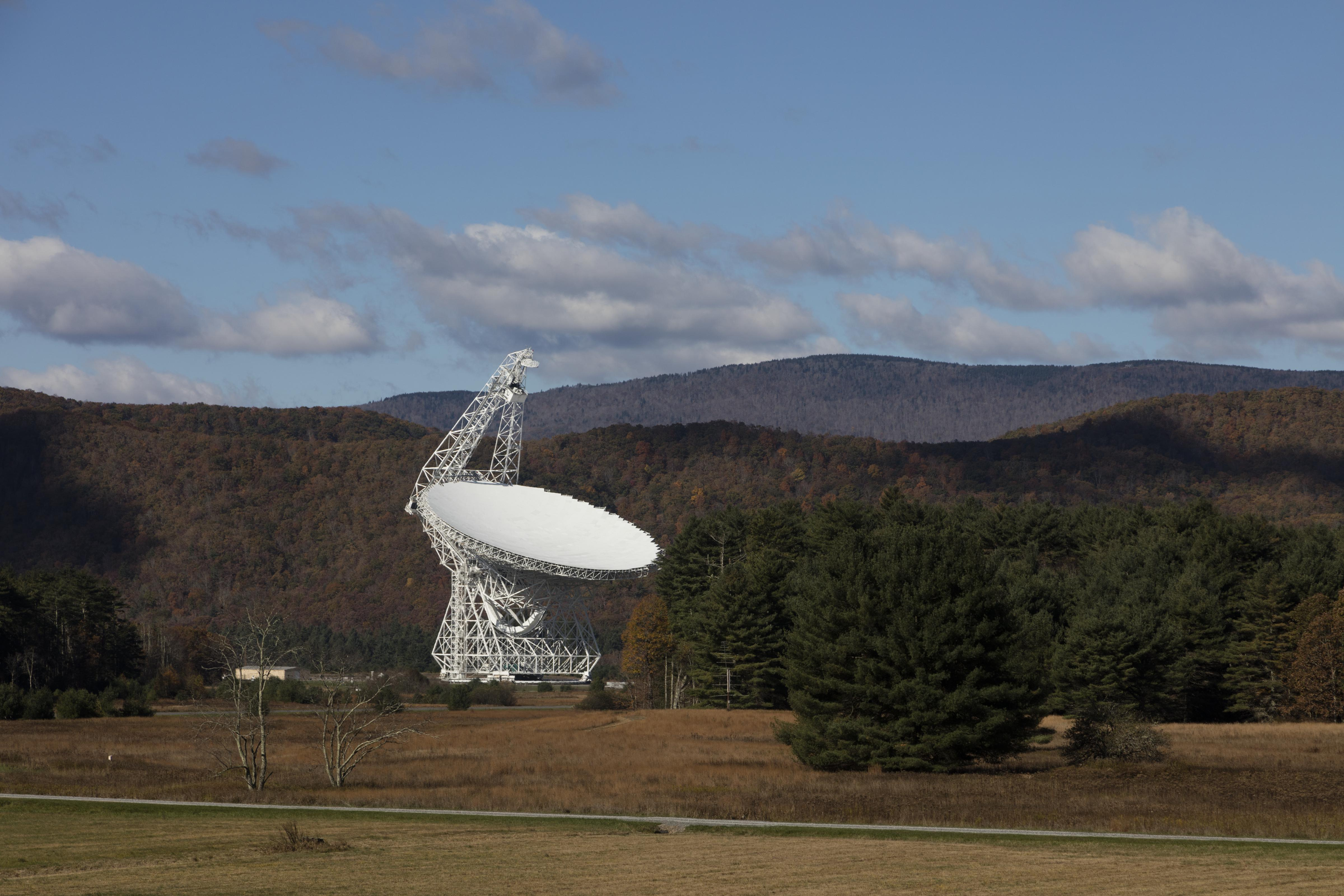 A radio telescope dish turned upward, listening